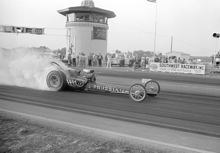 A car makes a burnout at the first NHRA Finals in Tulsa, Okla.