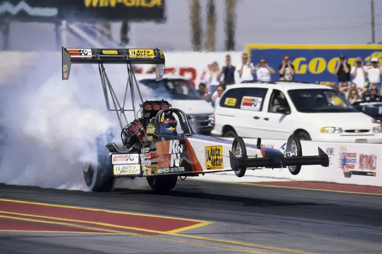 Second-generation Aussie nitro pilot Andrew Cowin showed the power and fury of a Top Fuel dragster by simultaneously wheelstanding and smoking the rear tires on this launch at the 1999 Phoenix event. 