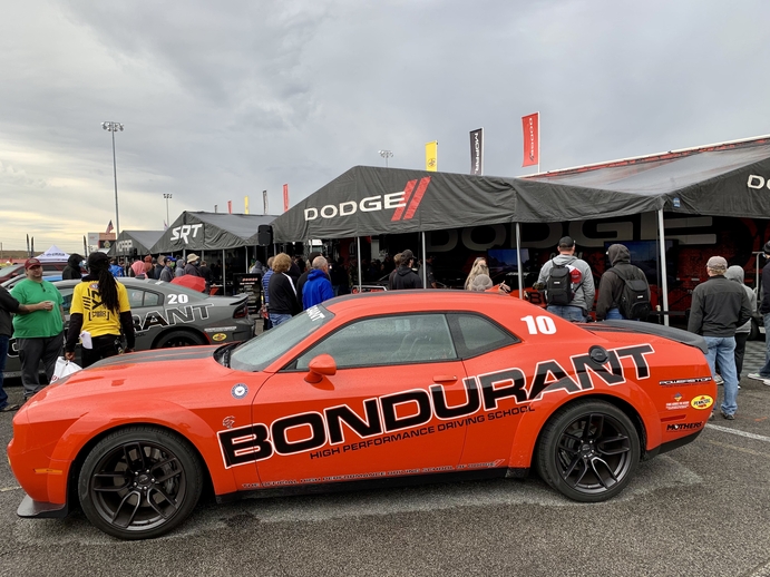 The Dodge and Mopar display at the NHRA Midwest Nationals features Bondurant Driving School Hellcat Challengers