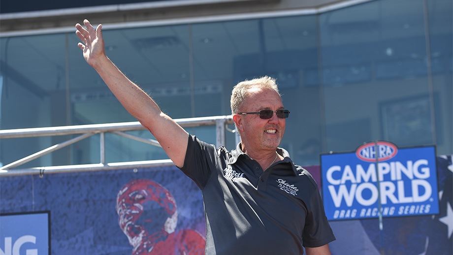 Top Alcohol Dragster driver Duane Shields waves to crowd