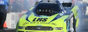 Tim Wilkerson's Funny Car explodes in a fireball in round one—but still advances