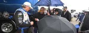 John force with fans during rain delay